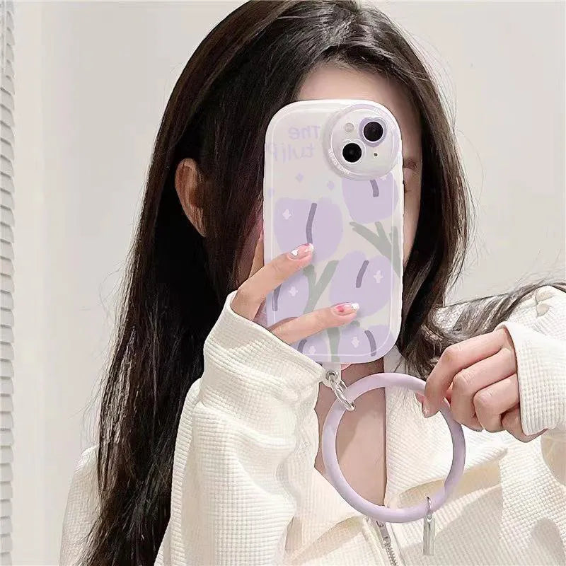 Purple transparent iPhone case with ring holder and tulip heart pattern, includes matching wrist strap