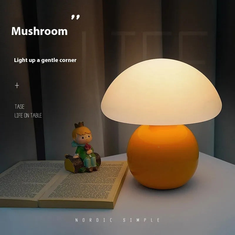 Cream ceramic mushroom table lamp with USB power cord on a bedside table, available in yellow