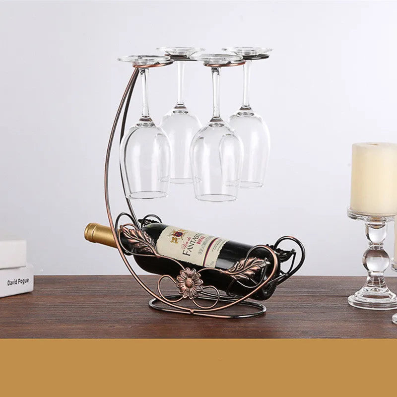 Iron wire wine rack decoration holding four goblets in a bronze finish on a shelf