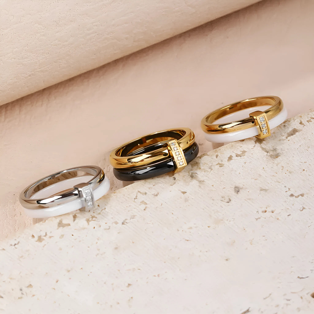 Women's titanium steel heart-shaped double ring with glossy stitching and zirconium accents in gold black.