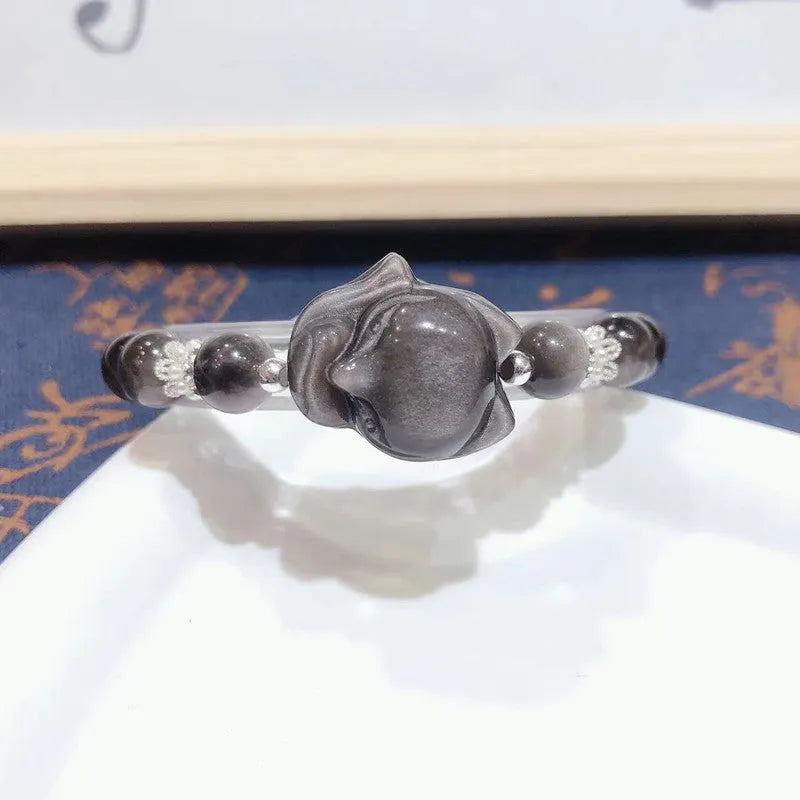 Natural silver stone big head fox bracelet with 8mm obsidian beads on a white background