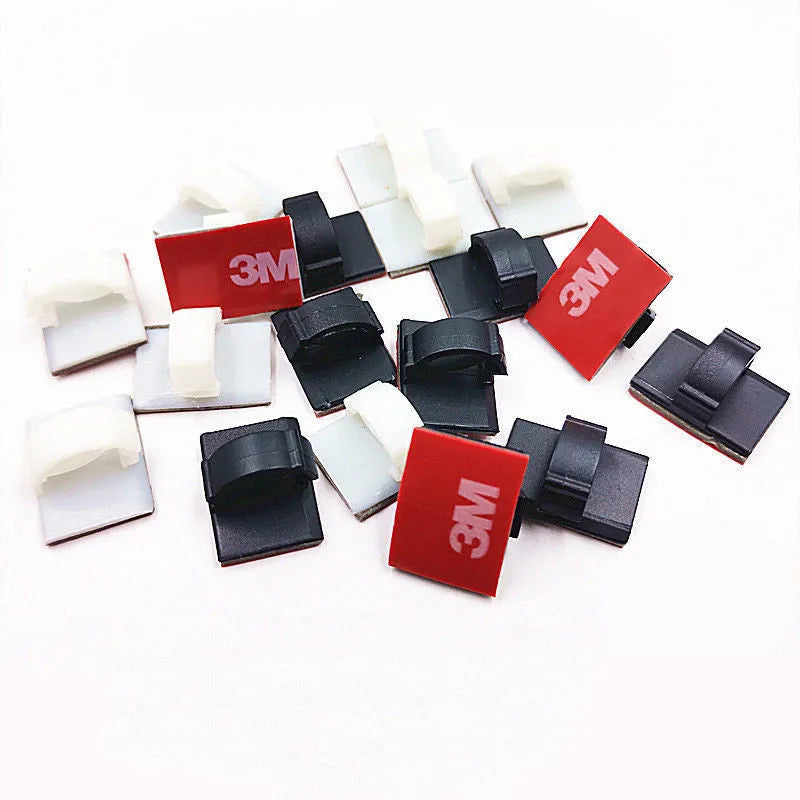 Black and white self-adhesive plastic wire buckles for securing cables, shown in assorted pack sizes.