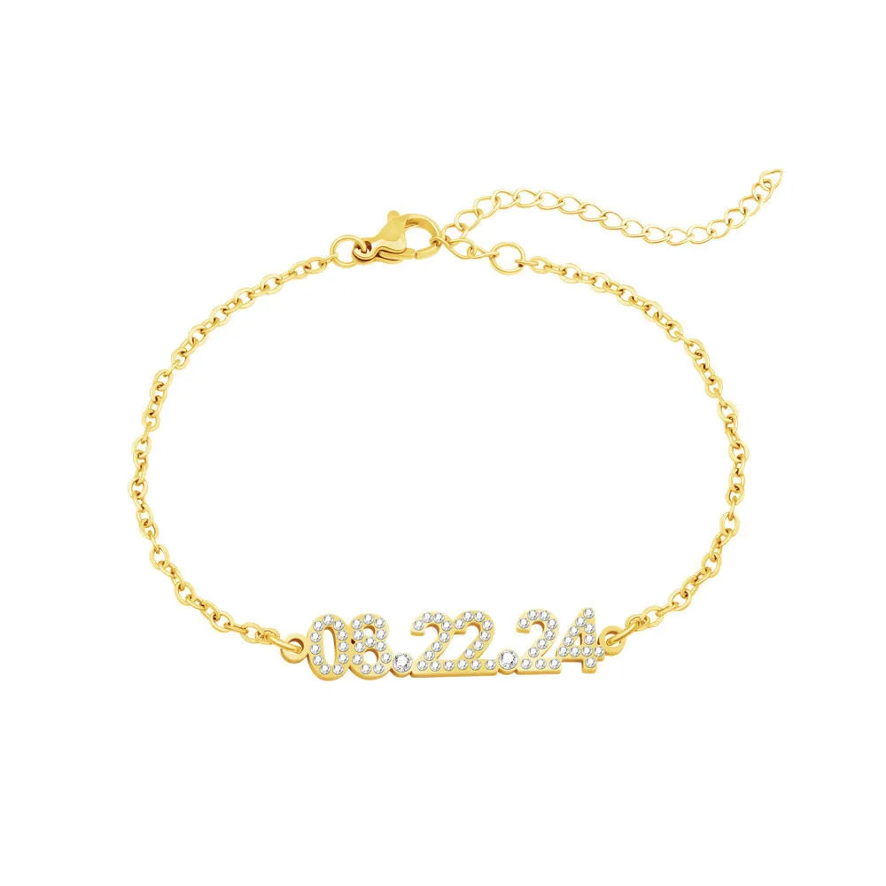 Stainless steel digital bracelet with diamond-studded numbers in gold finish on wrist.