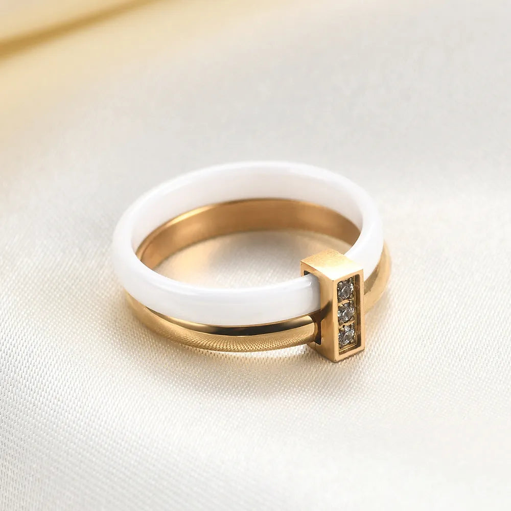 Glossy black ceramic women's ring with silver stitch-inlaid zirconium detail on a geometric band.
