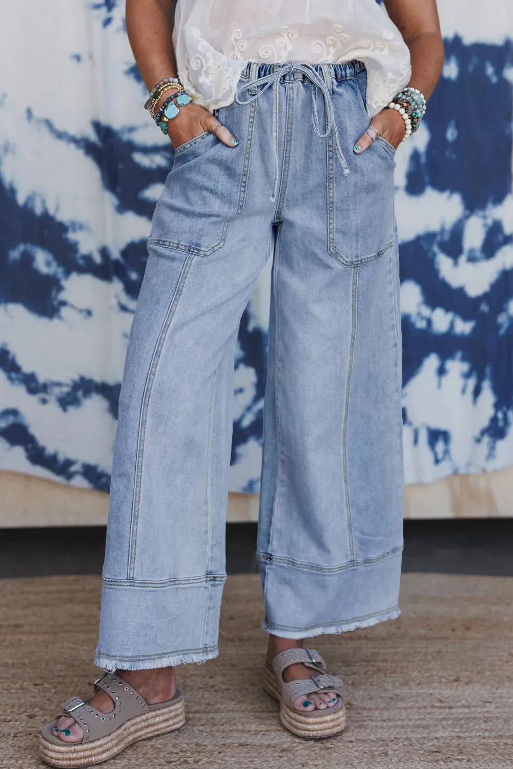 Beau Blue wide leg denim trousers with drawstring waist and raw unfinished hem detail