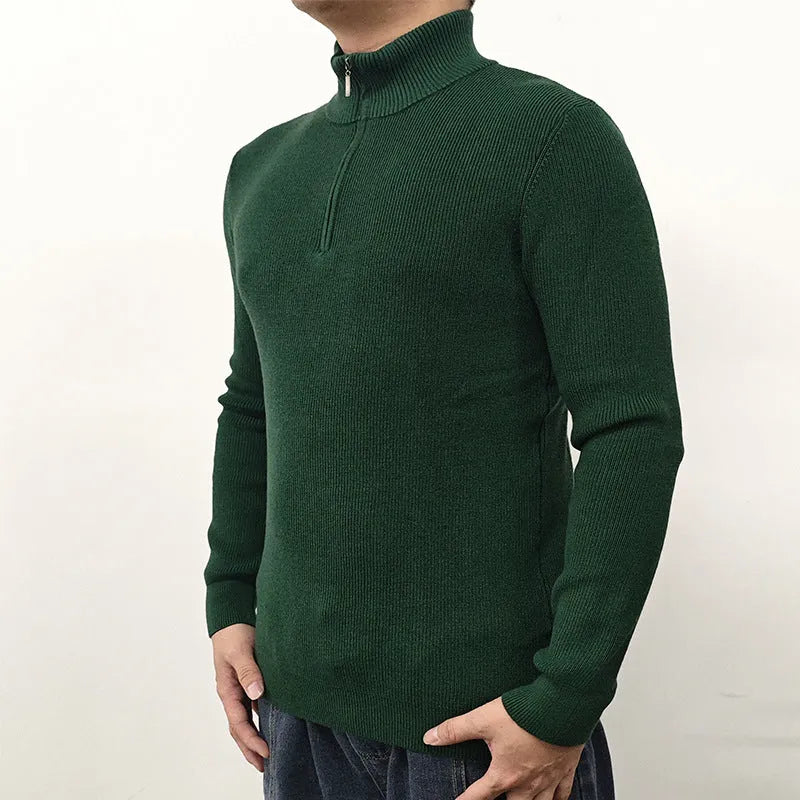 Man wearing a grey half turtleneck zip front sweater, a casual cotton blend pullover.
