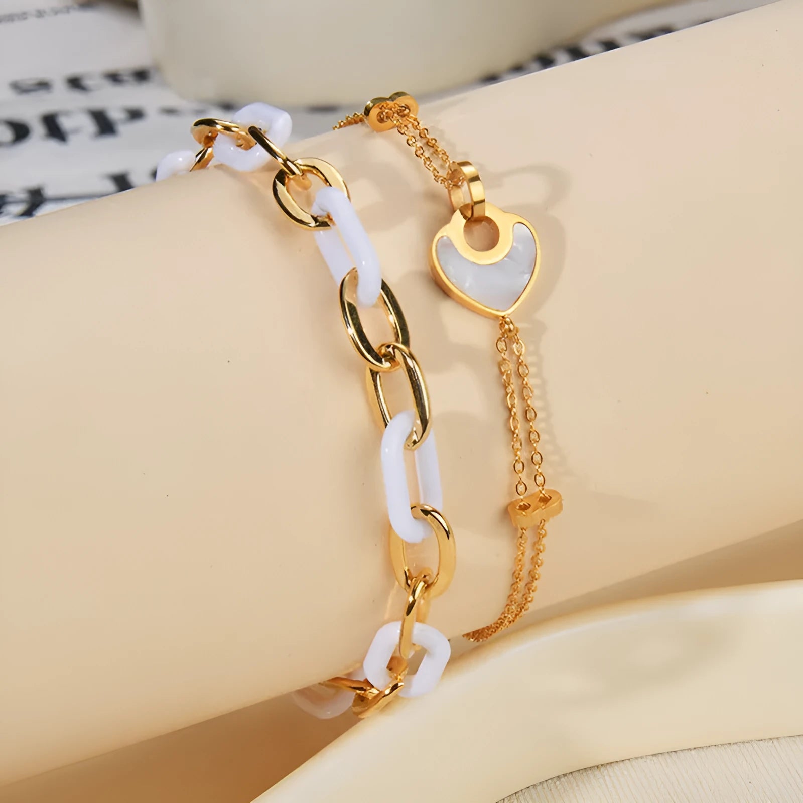 Stainless steel bracelet for women with a double-layered red resin heart charm on a metallic chain.