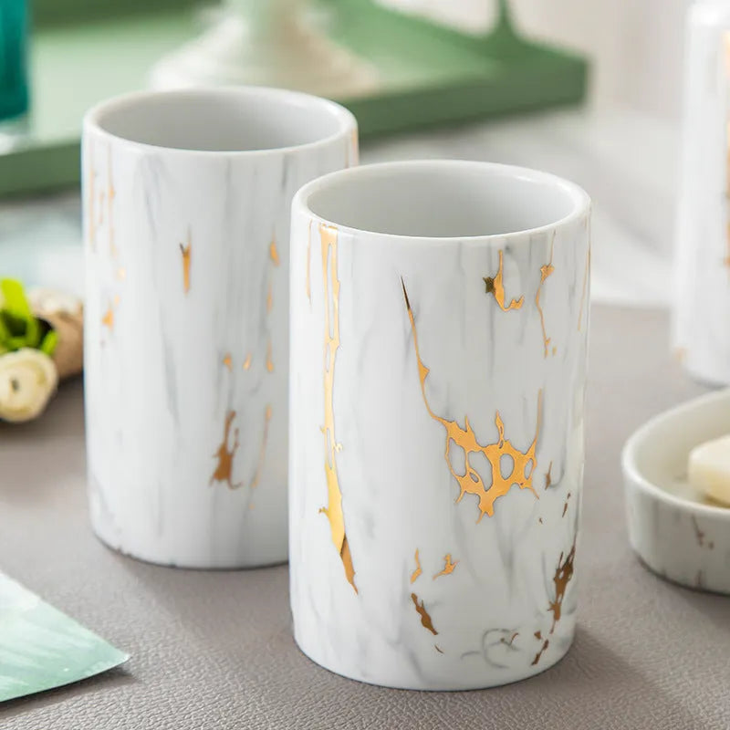 White ceramic bathroom wash set with marble finish showing two cups, soap box, and latex bottle