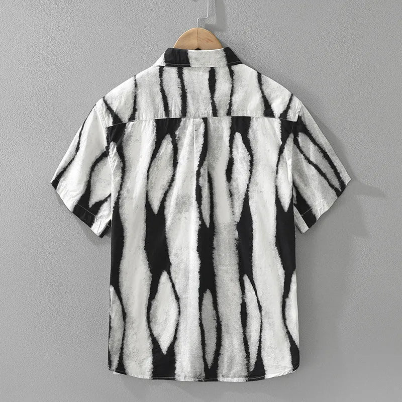 Man wearing a black and white striped retro-style short sleeve cotton shirt with a loose fit.