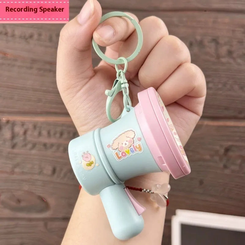 Green or yellow plastic cartoon horn keychain ornament on plastic key ring