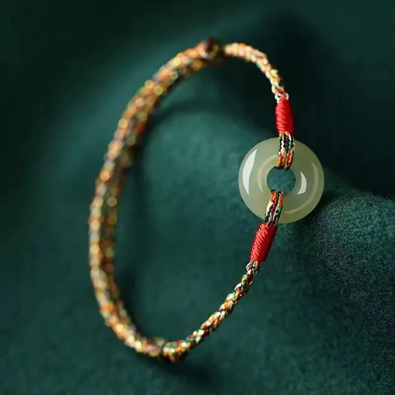 Handmade woven rope bracelet with silver peace buckle clasp on colourful braided cord