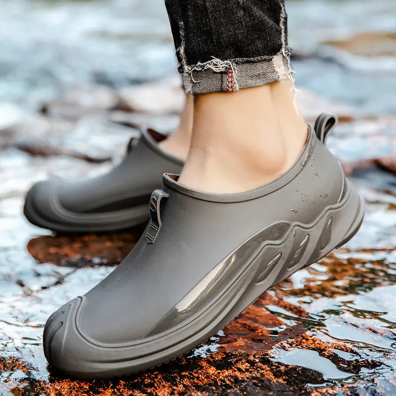 Men's solid colour short rain boots with plastic upper, shown in black, grey, and green.