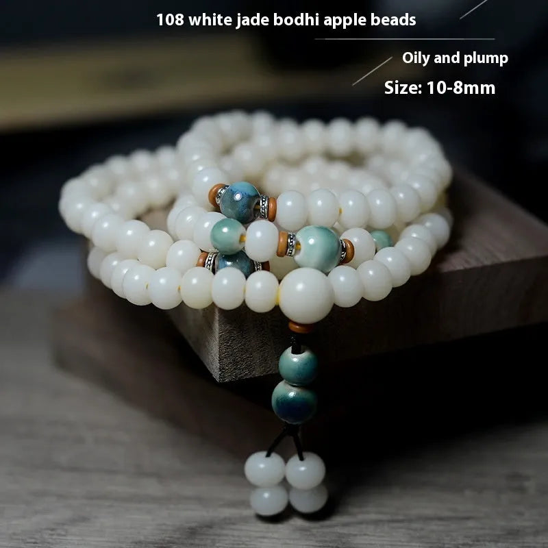 White jade bodhi root bracelet with 108 flat round beads in two sizes on wrist