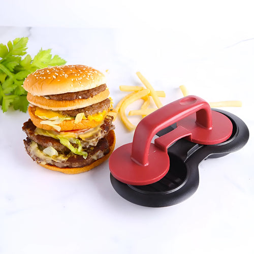 Black or red food-grade ABS burger press mould with oil paper liners on a kitchen surface.