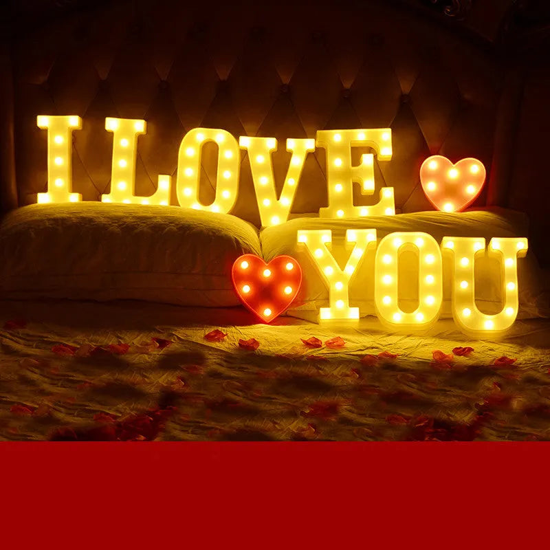 Plastic LED letter light decoration spelling a message, 22cm in height.