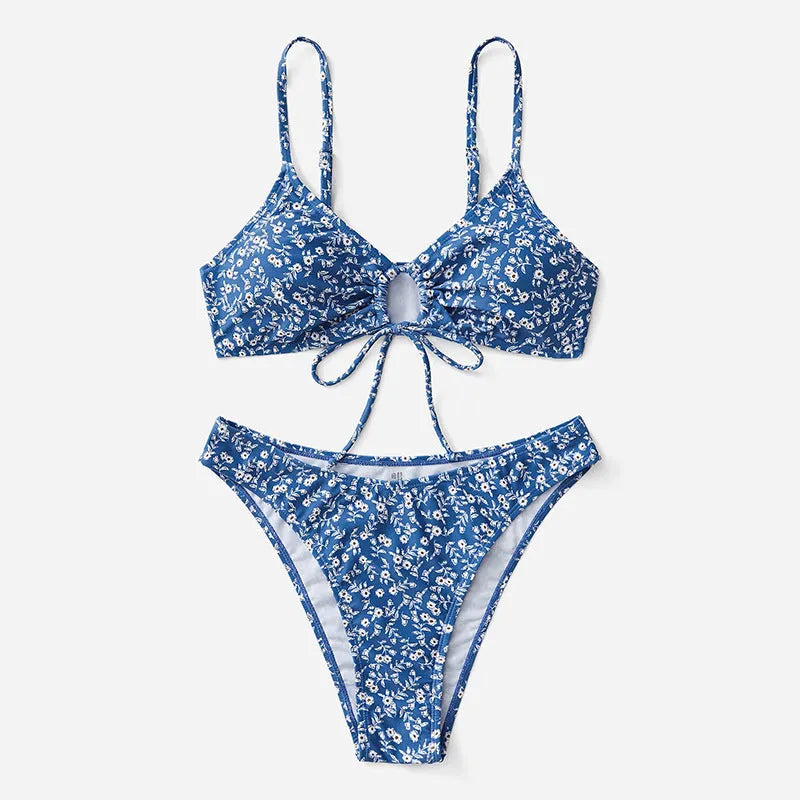 Blue three-piece swimsuit set with top and shorts on white background