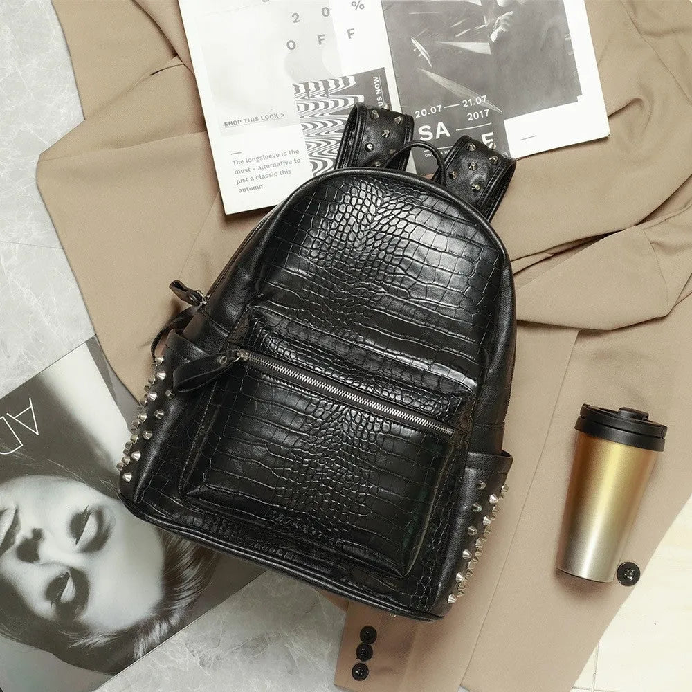 Black oil-wax PU leather computer schoolbag with rivets, showing large 36-55L capacity.
