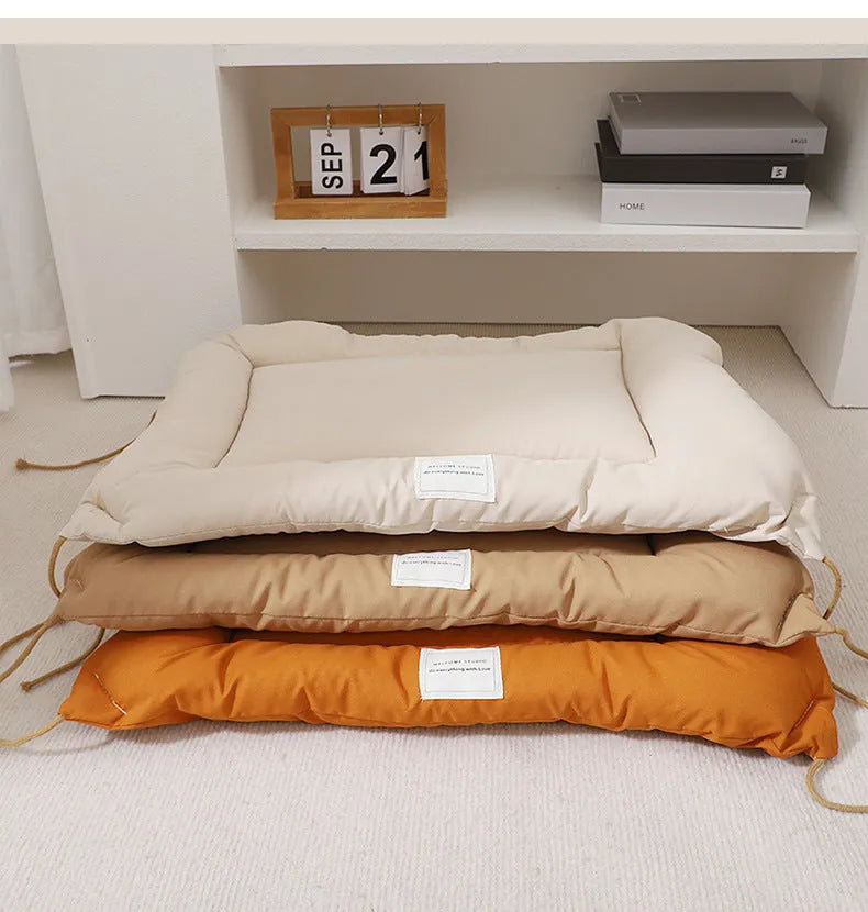 Beige pet cage cushion secured inside a metal dog crate, showing tie straps.
