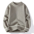 Man wearing a loose-fit grey casual pullover sweater with a round neck and long sleeves.