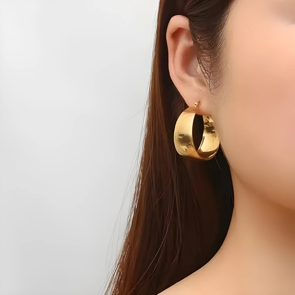Stainless steel curved earrings with electroplated gold or steel finish in 25mm or 30mm sizes