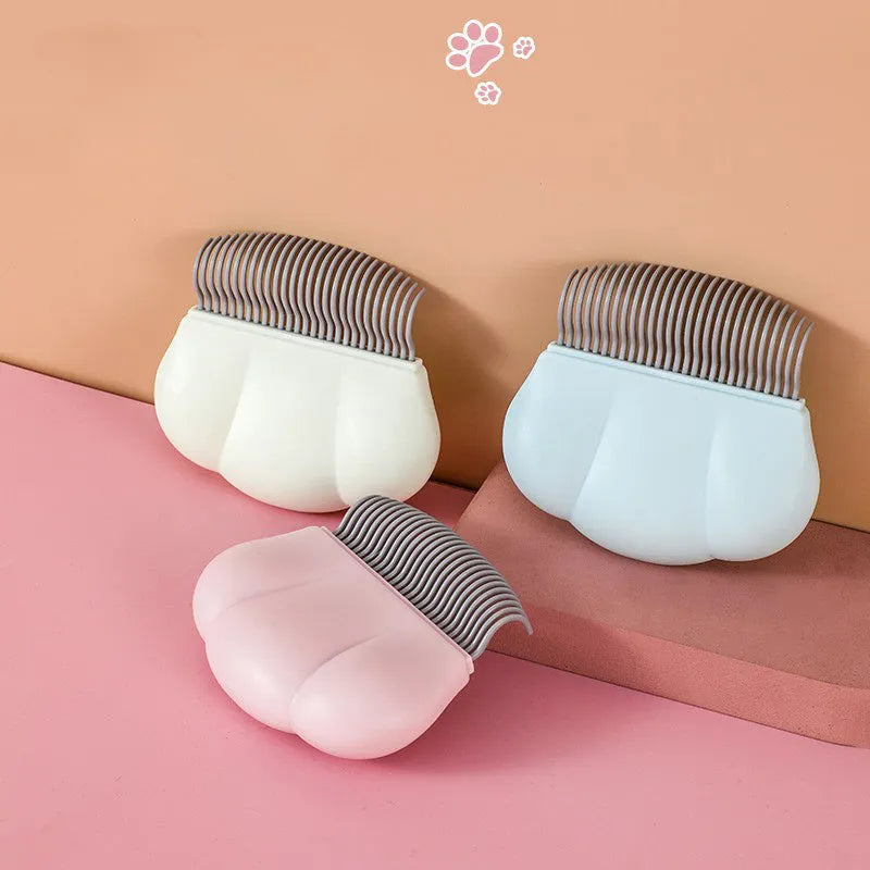 Blue Paw Soft deshedding brush for cats and dogs on a white surface.