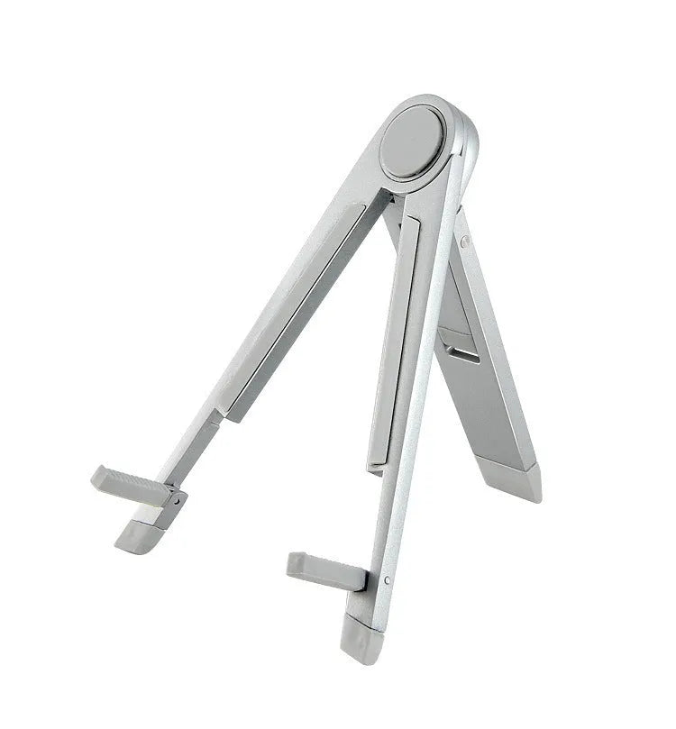 Silver metal adjustable triangle stand holding a mobile phone on a flat desktop