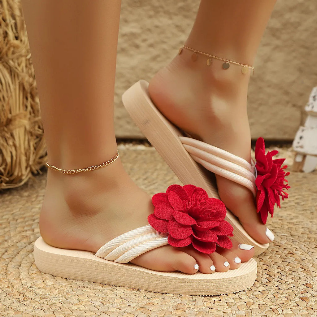 Women's solid colour PU flower flip-flops on a flat surface, showing the strap with decorative flower detail