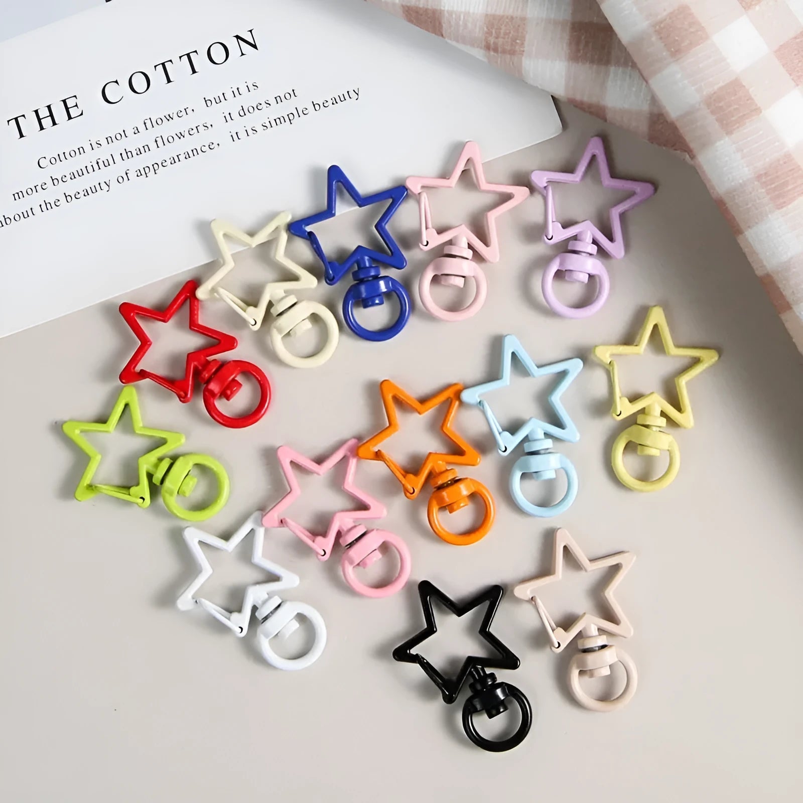 Metal five-pointed star snap button keychain with colour paint finish in alloy, small size, thirteen colour options including beige and sapphire blue