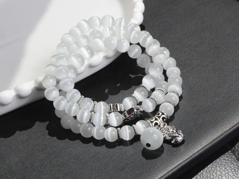 Opal crystal cat eye bracelet with lucky cat charm, shown in one of six colour options.