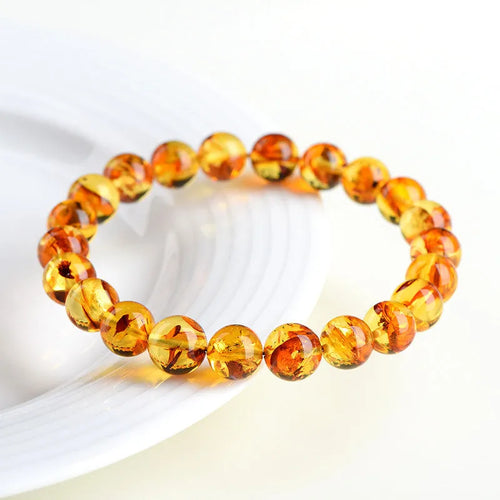 Natural yellow piebald amber bracelet with geometry beads showing flower spot patterns