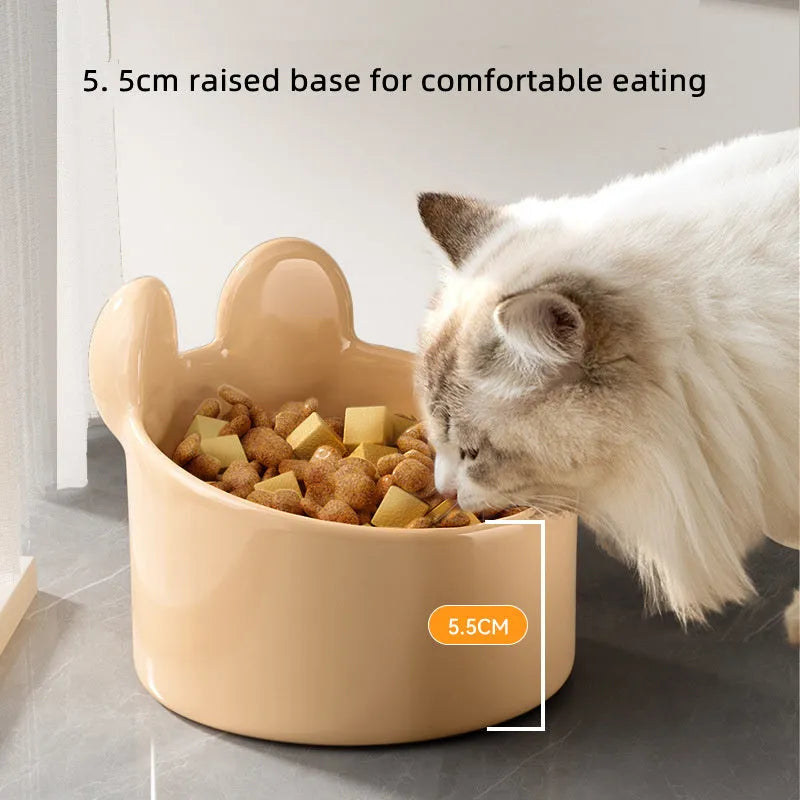 White and yellow ceramic pet bowls with raised neck guards in two sizes.