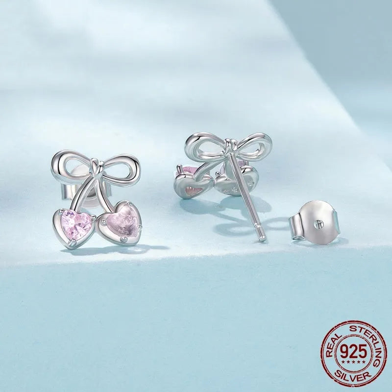 Sweet cherry stud earrings in 925 sterling silver with heart silhouette on light background