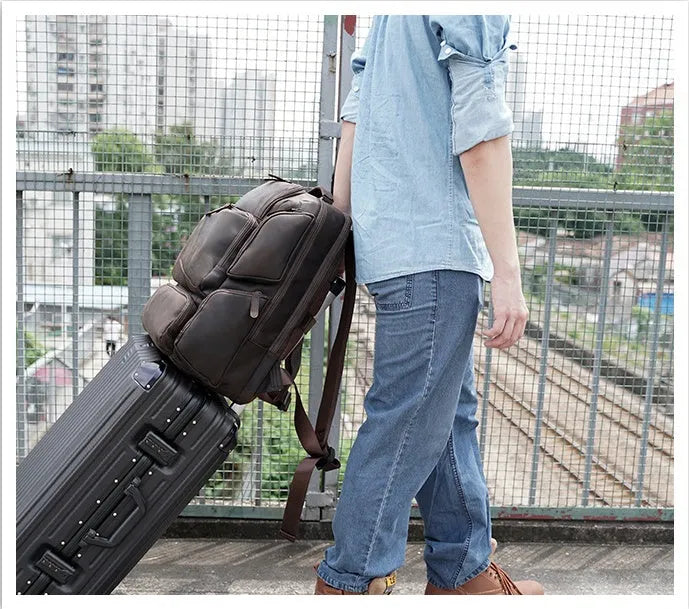 Dark brown leather backpack for men with 17-inch laptop compartment and multiple internal organisers