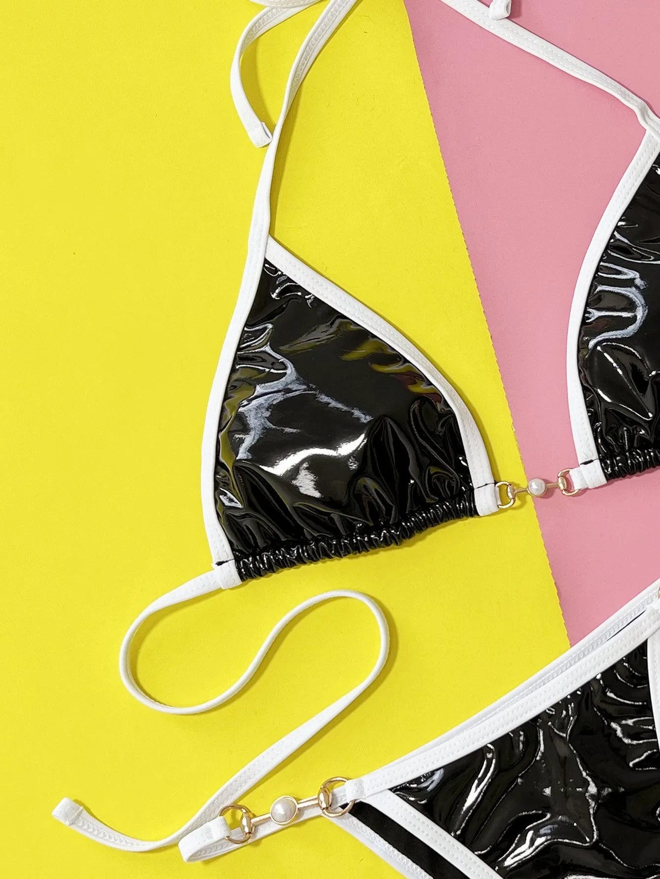Black women's solid colour bikini swimsuit with triangle top and split briefs.