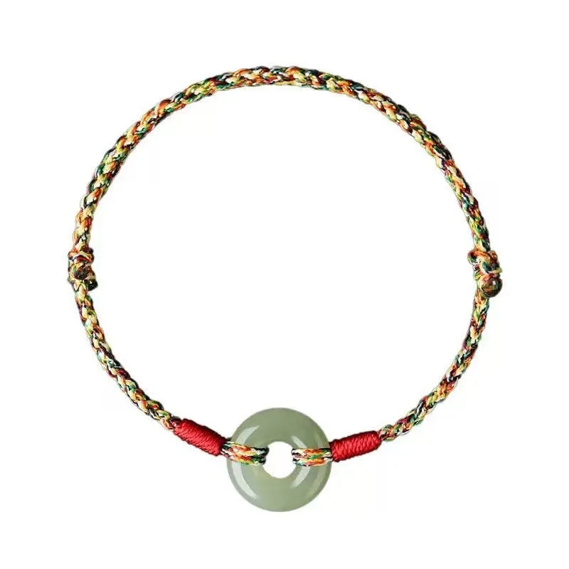 Handmade woven rope bracelet with silver peace buckle clasp on colourful braided cord