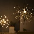 Outdoor waterproof dandelion string lights with warm colour glow on a garden fence