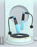 Blue cordless Bluetooth skipping rope with electronic counter and weighted ball on a floor