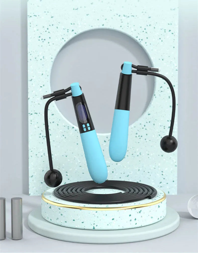 Blue cordless Bluetooth skipping rope with electronic counter and weighted ball on a floor