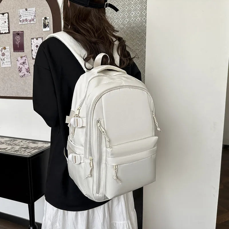 Women's large capacity solid colour schoolbag in black with curved shoulder strap and nylon material