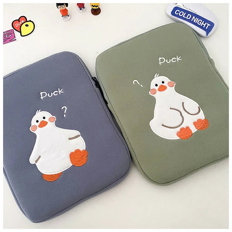 Blue cotton tablet case with cartoon duck embroidery and a zipper closure.