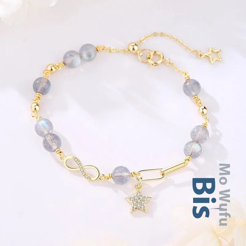 A women's adjustable Mobius crystal bracelet with a constellation design, showing the gray moonstone colour option.