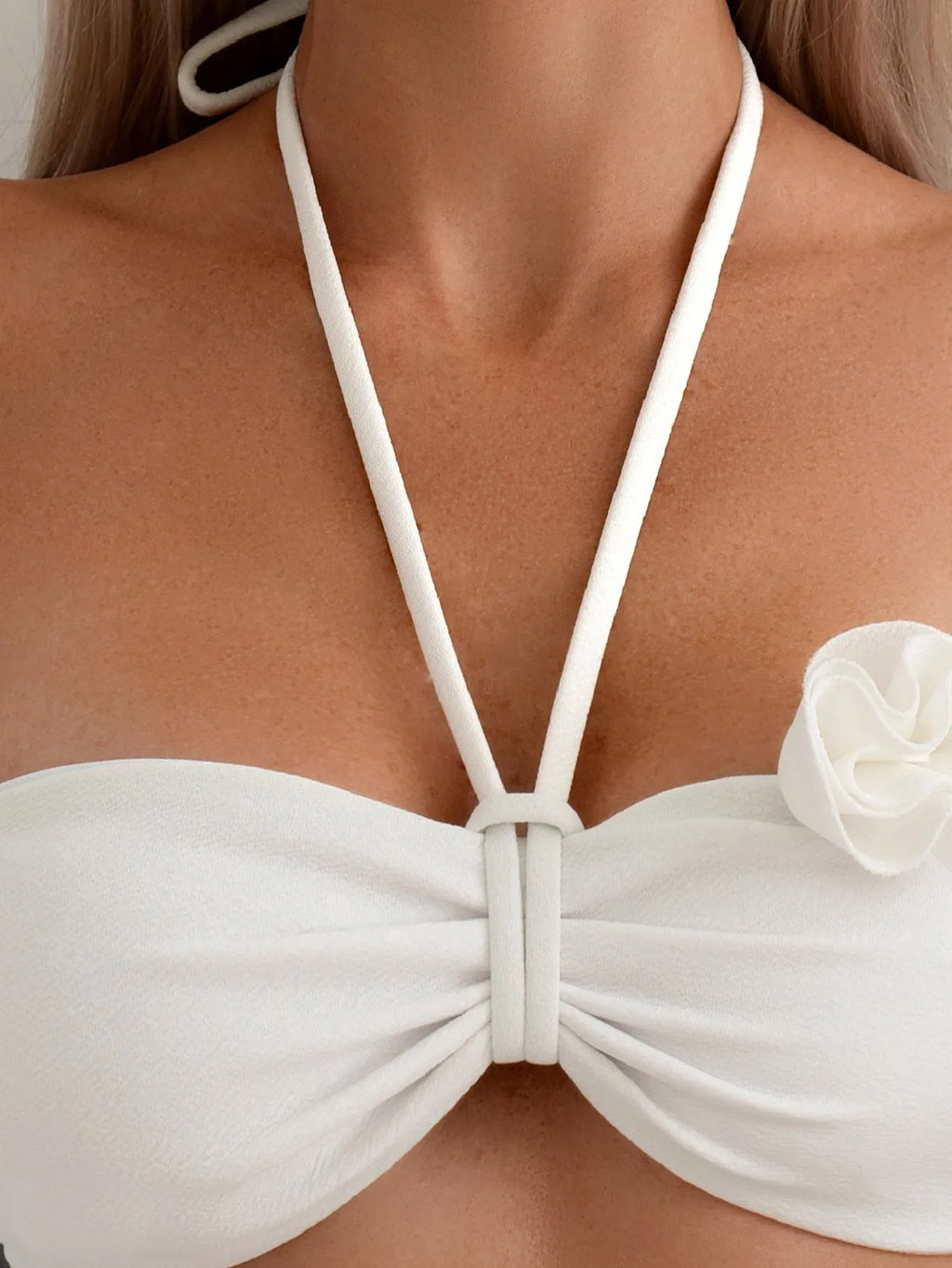 White halter swimsuit with three-dimensional floral lace-up front and split sides