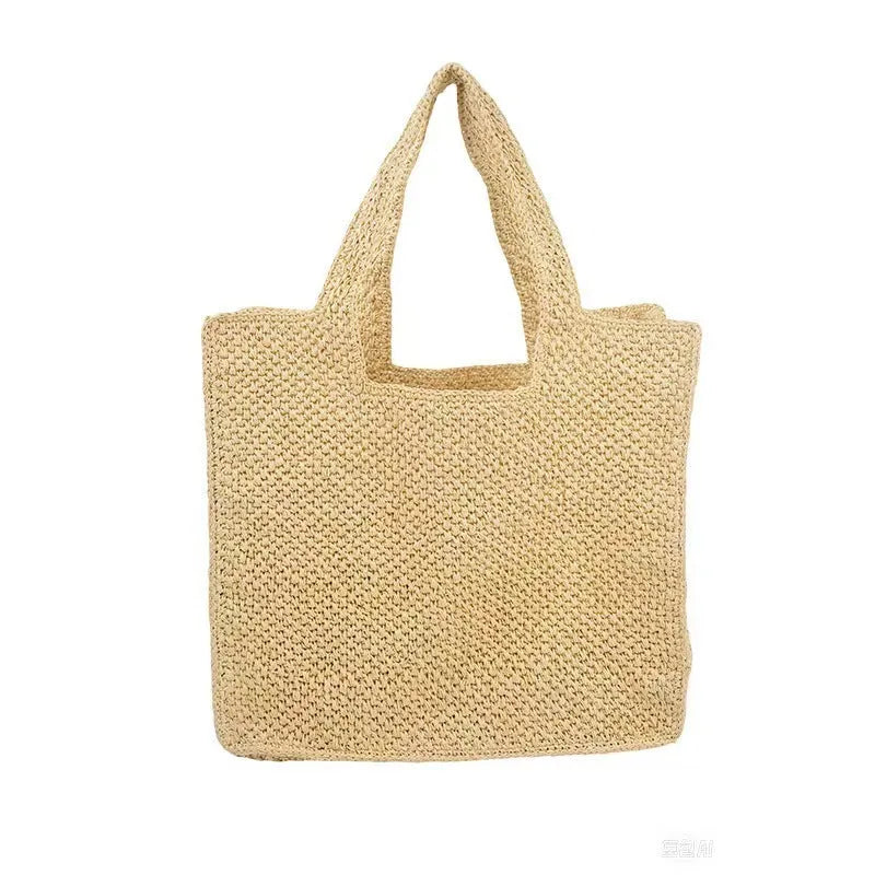 Straw woven bucket tote bag in beige colour showing woven texture and open top design