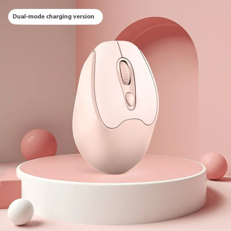 Bluetooth wireless mouse in choice of girl pink, milk tea pink, grey or green colours on a desk next to a laptop.