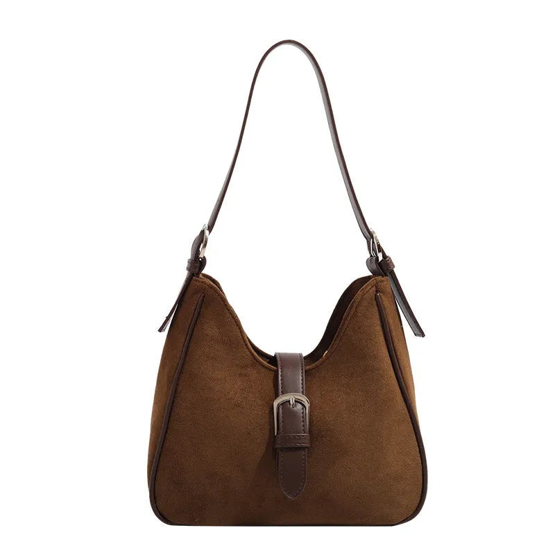 Retro suede leather underarm shoulder bag in brown with double connector straps on a white background