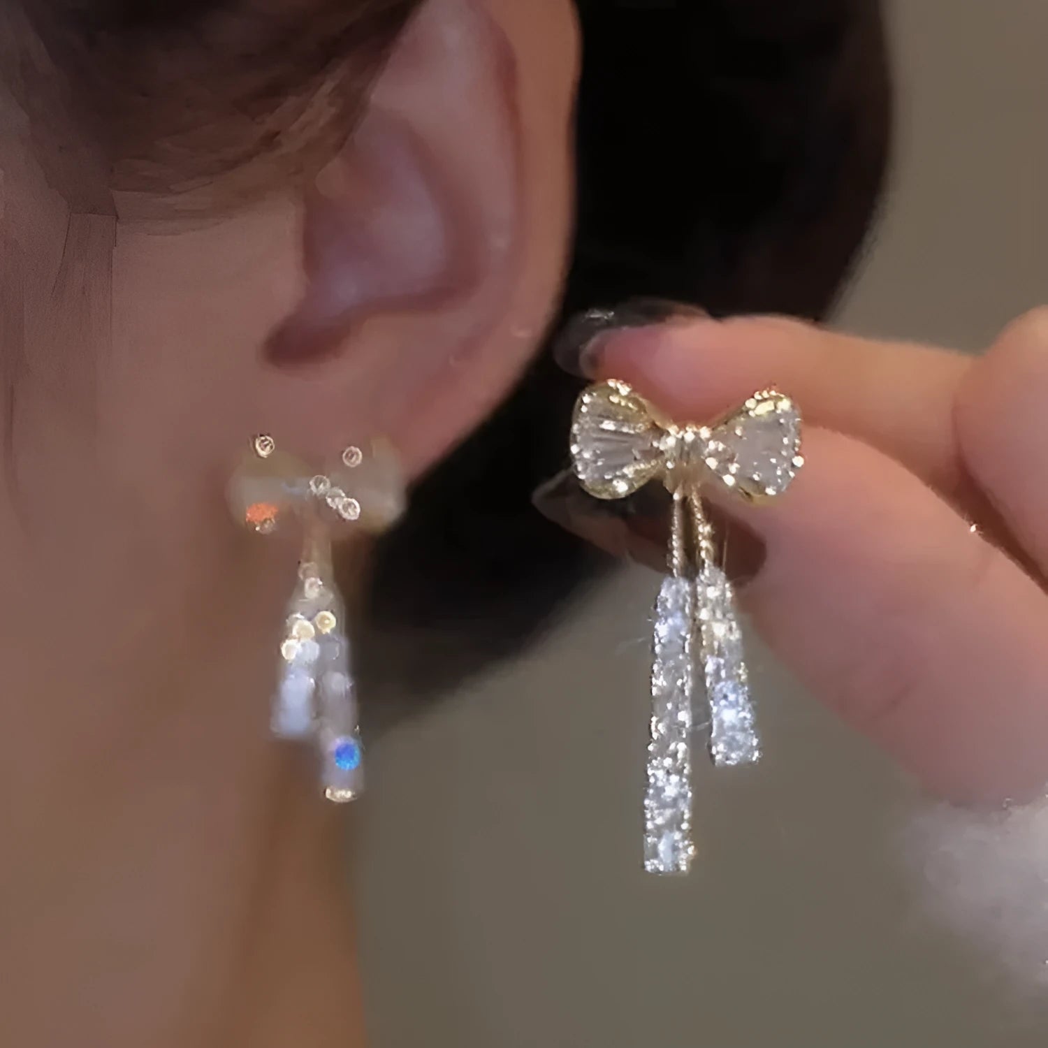 Gold butterfly earrings with rhinestones and bow element on alloy base