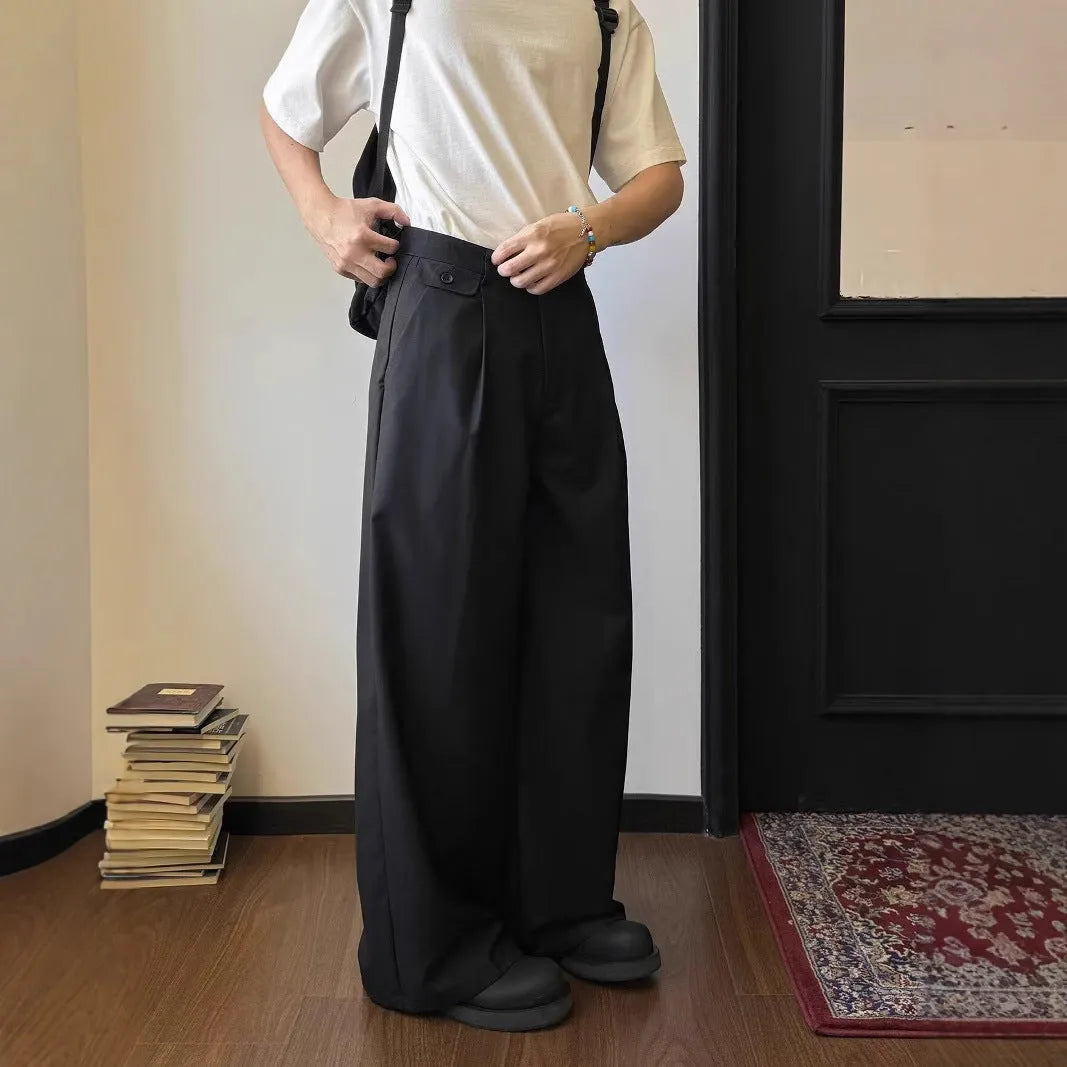 Men's straight-leg wide trousers in brown and black, showing loose fit and casual style.