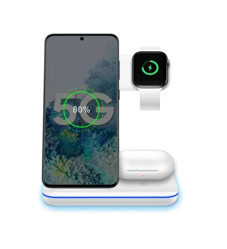 White three-in-one wireless charging stand holding a mobile phone, a smartwatch, and wireless earbuds on a desk.
