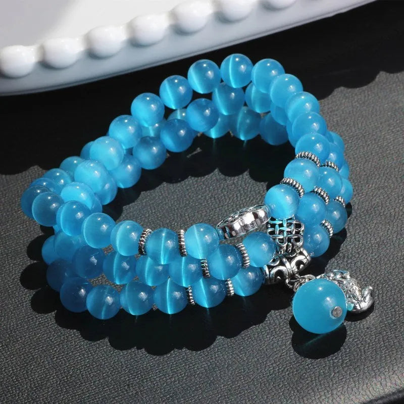 Opal crystal cat eye bracelet with lucky cat charm, shown in one of six colour options.