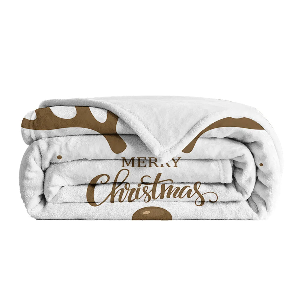 White flannel velvet deer antler pattern Christmas blanket on a sofa